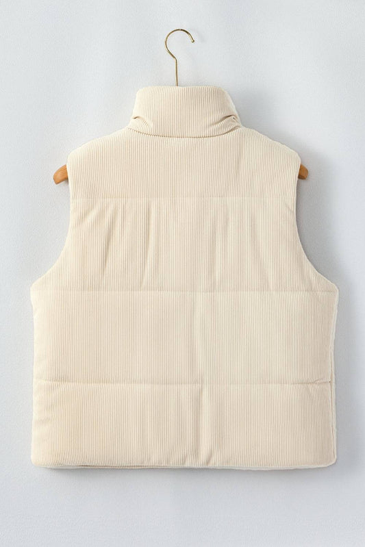 Beige puffer vest on a hanger against a light gray background