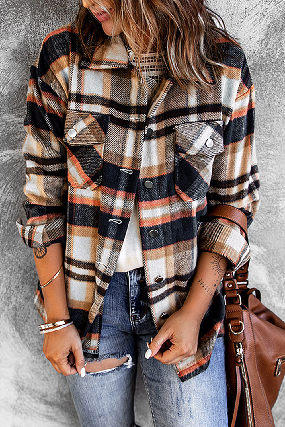Person wearing a plaid shirt with a gray background