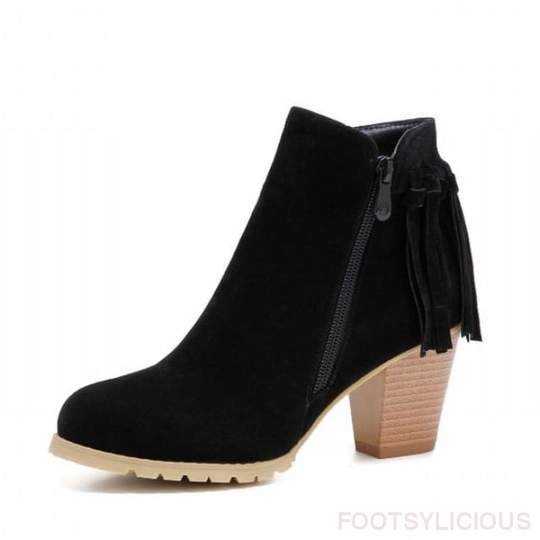 Black suede ankle boot with fringes on a white background