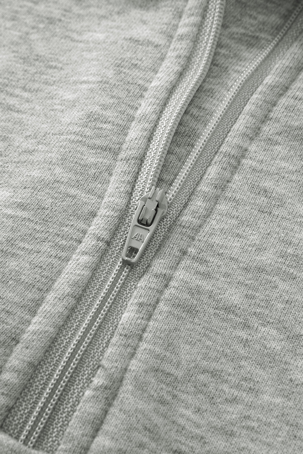 Close-up of a zipper on gray fabric