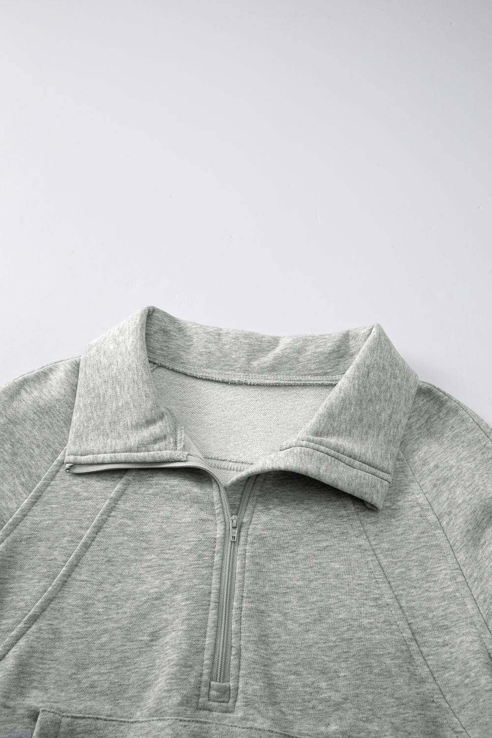 Gray pullover with a collar on a light gray background