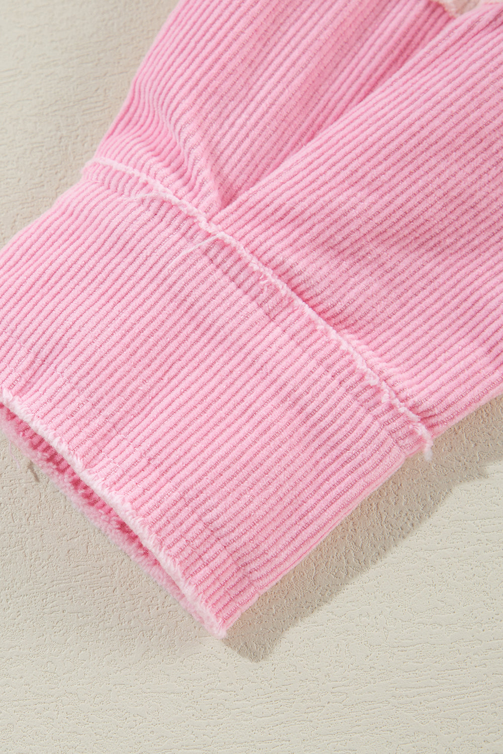 Close-up of a pink textured fabric on a light background