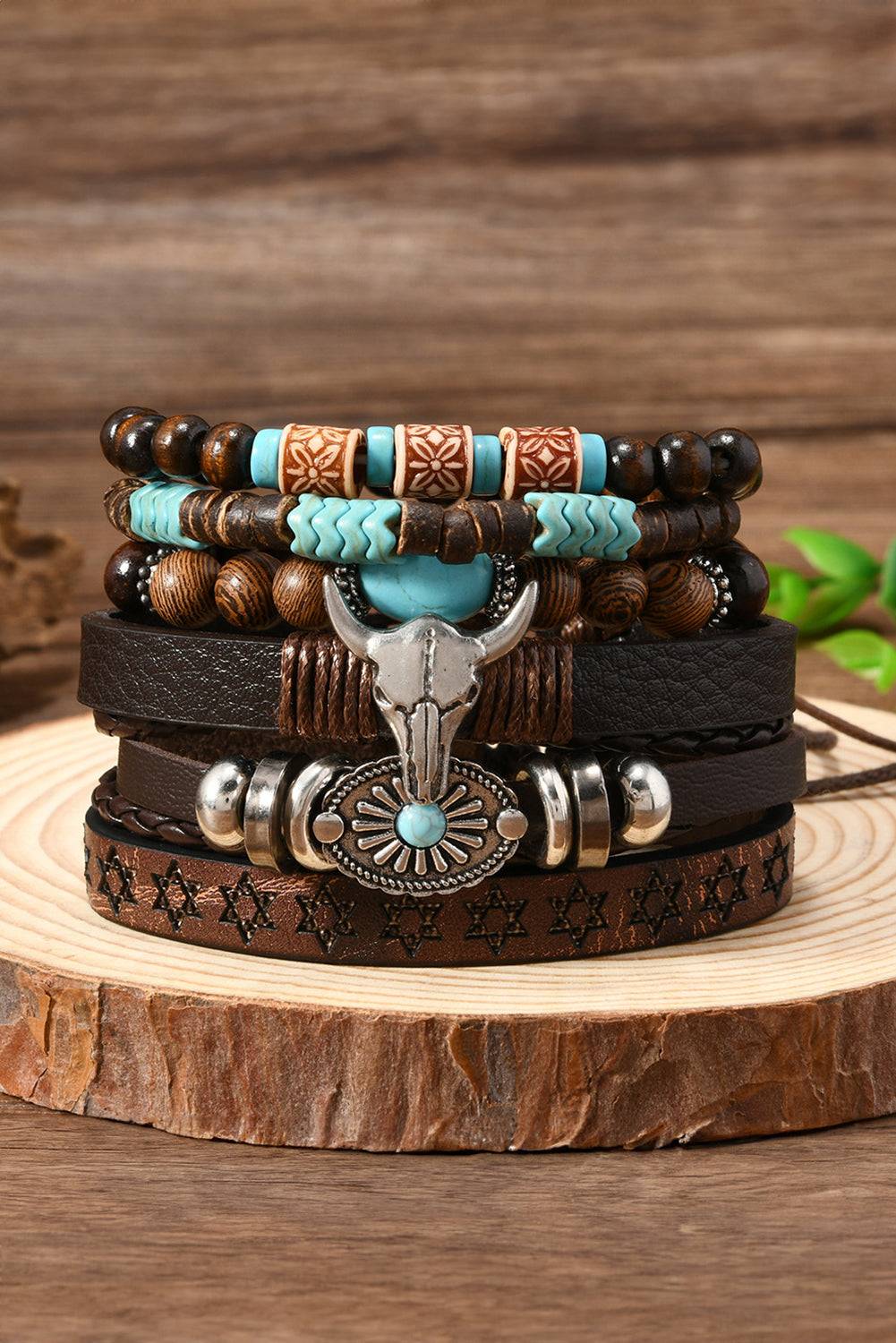 Stack of leather and beaded bracelets with decorative elements on a wooden surface