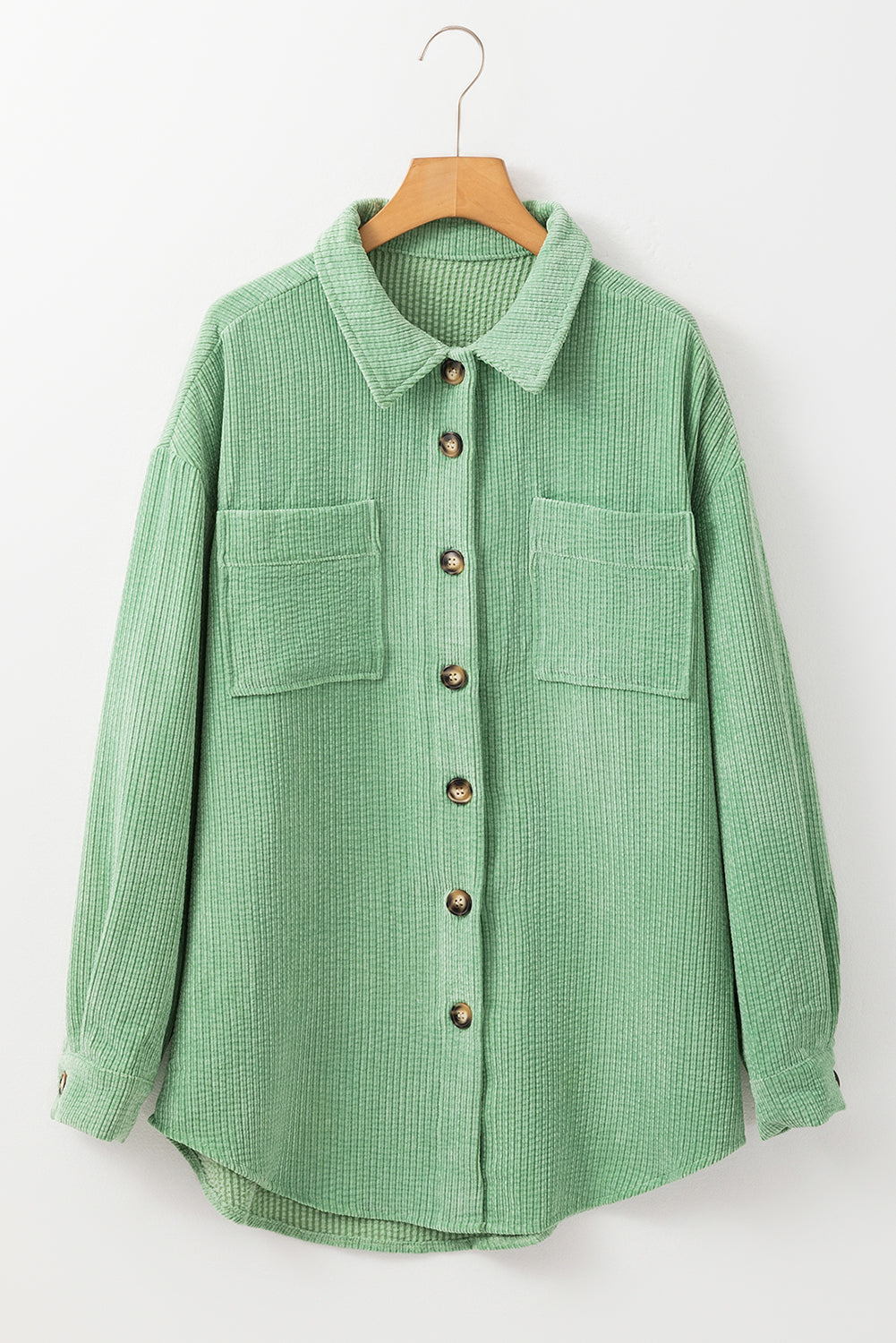 Green checkered shirt on a hanger against a white background