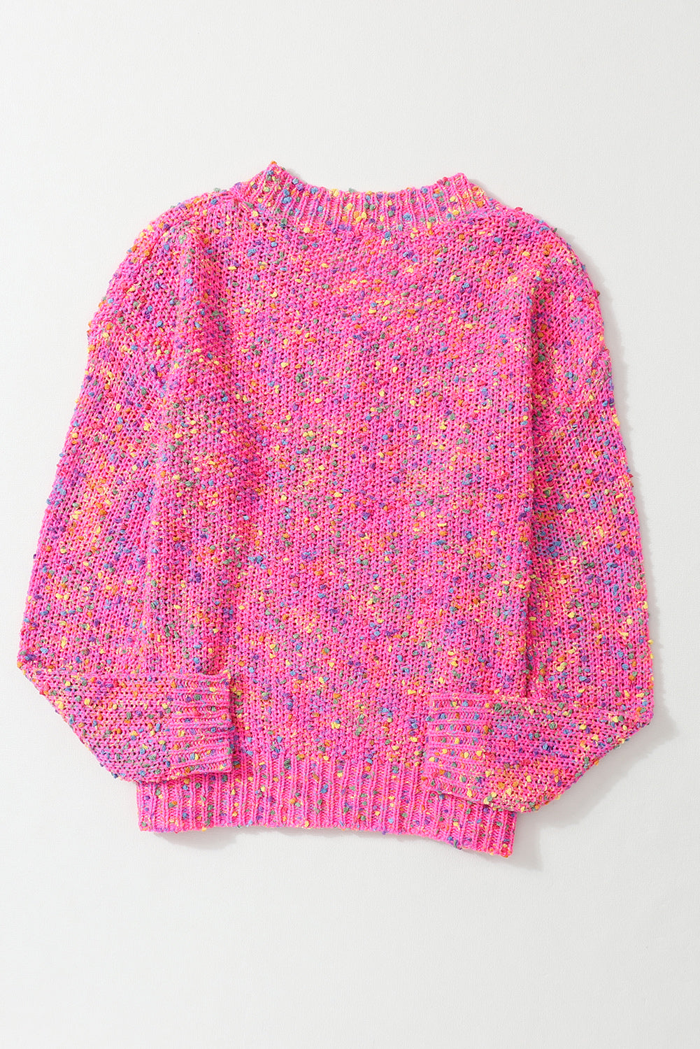 Pink knitted sweater with multicolor pattern on a light gray background