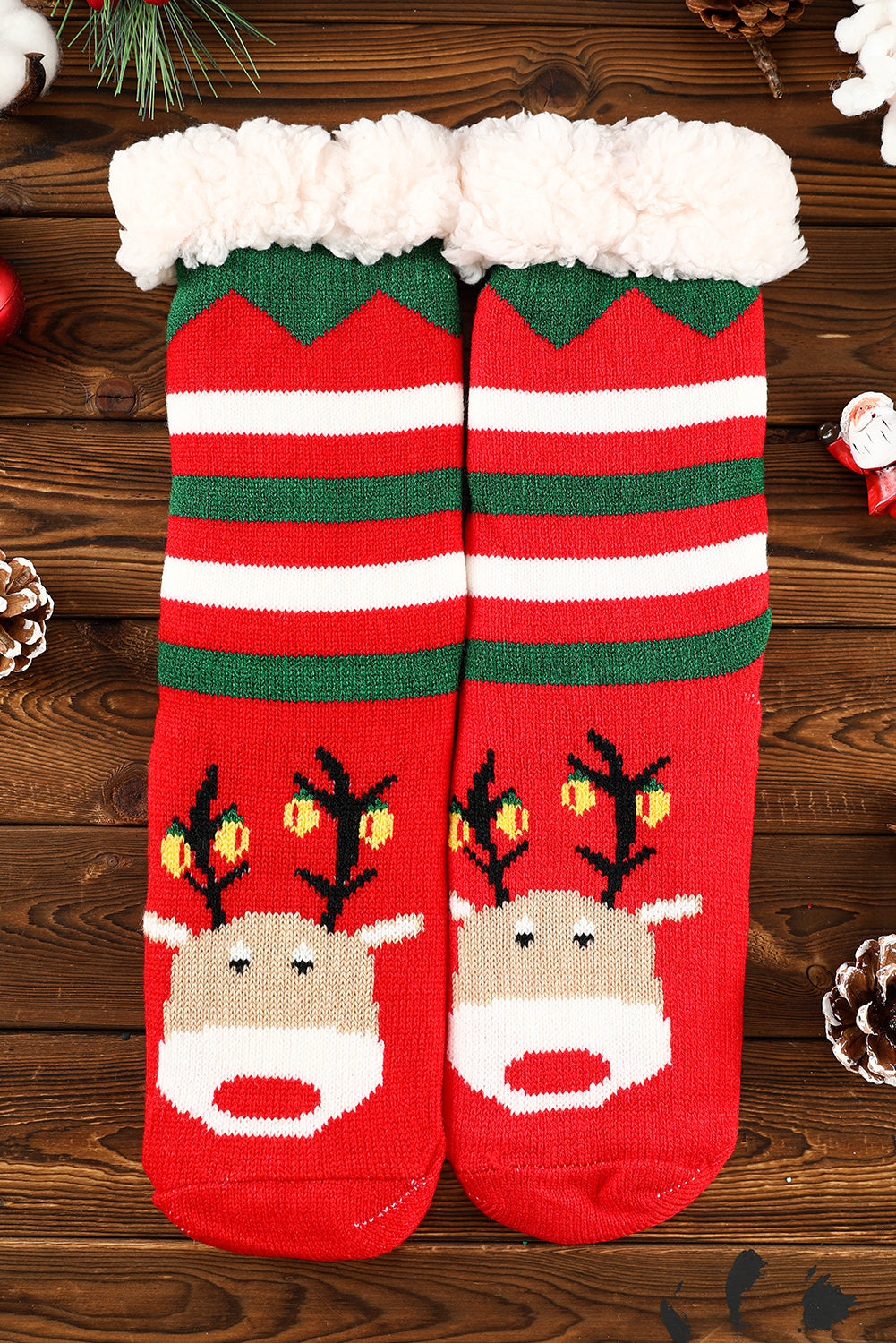 Red Christmas socks with reindeer design on a wooden surface