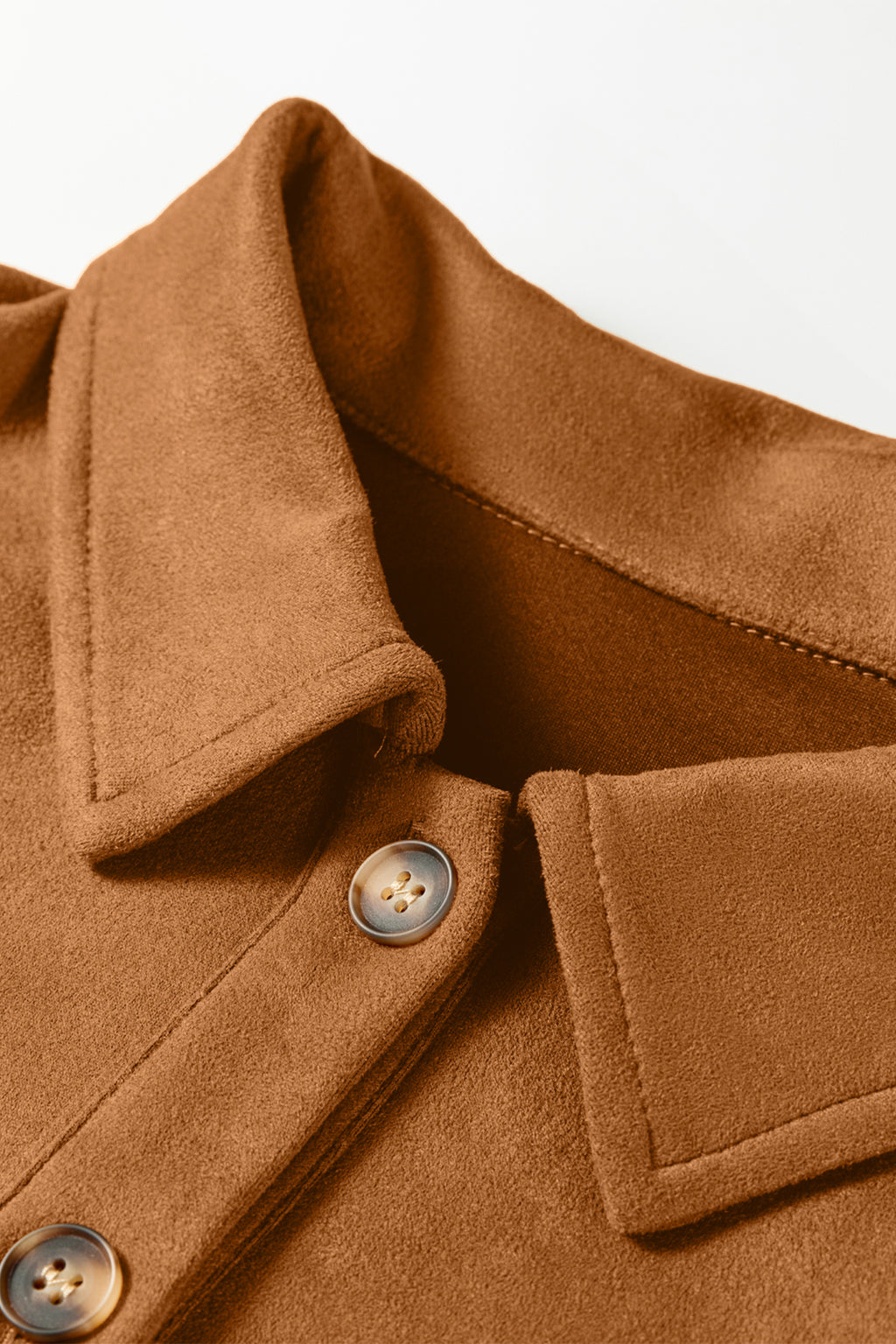 Close-up of a brown coat with buttons on a light background