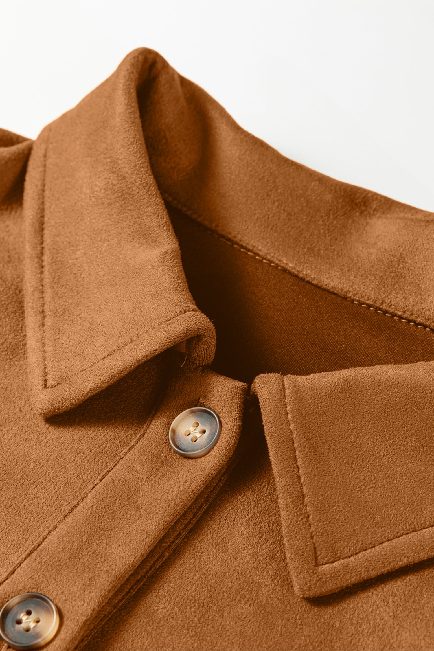 Close-up of a brown coat with buttons on a light background