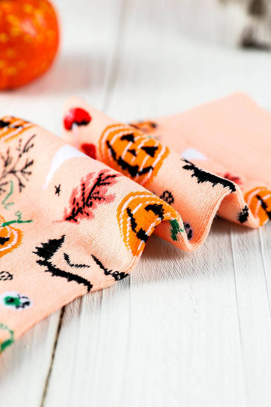 Halloween-themed fabric with pumpkins and ghosts on a wooden surface