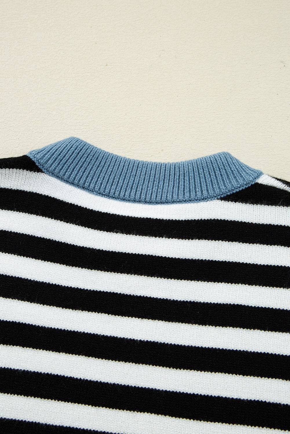Close-up of a striped sweater with blue collar on a beige background