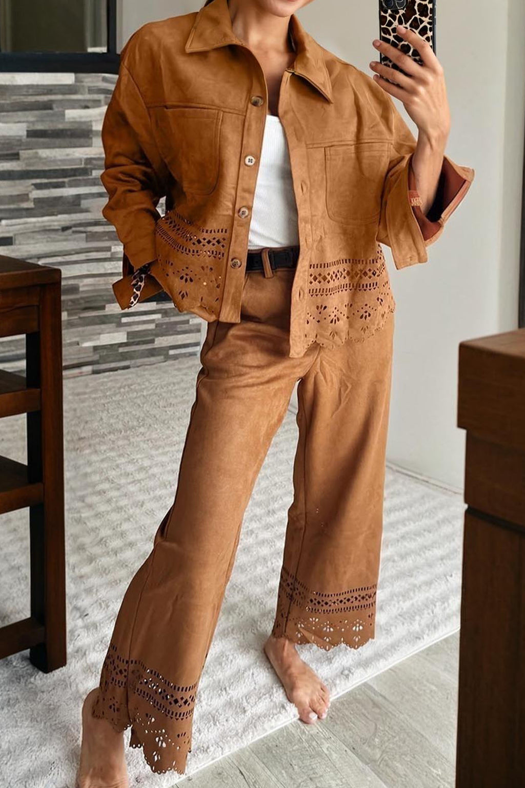 Person wearing a brown outfit with lace details indoors.