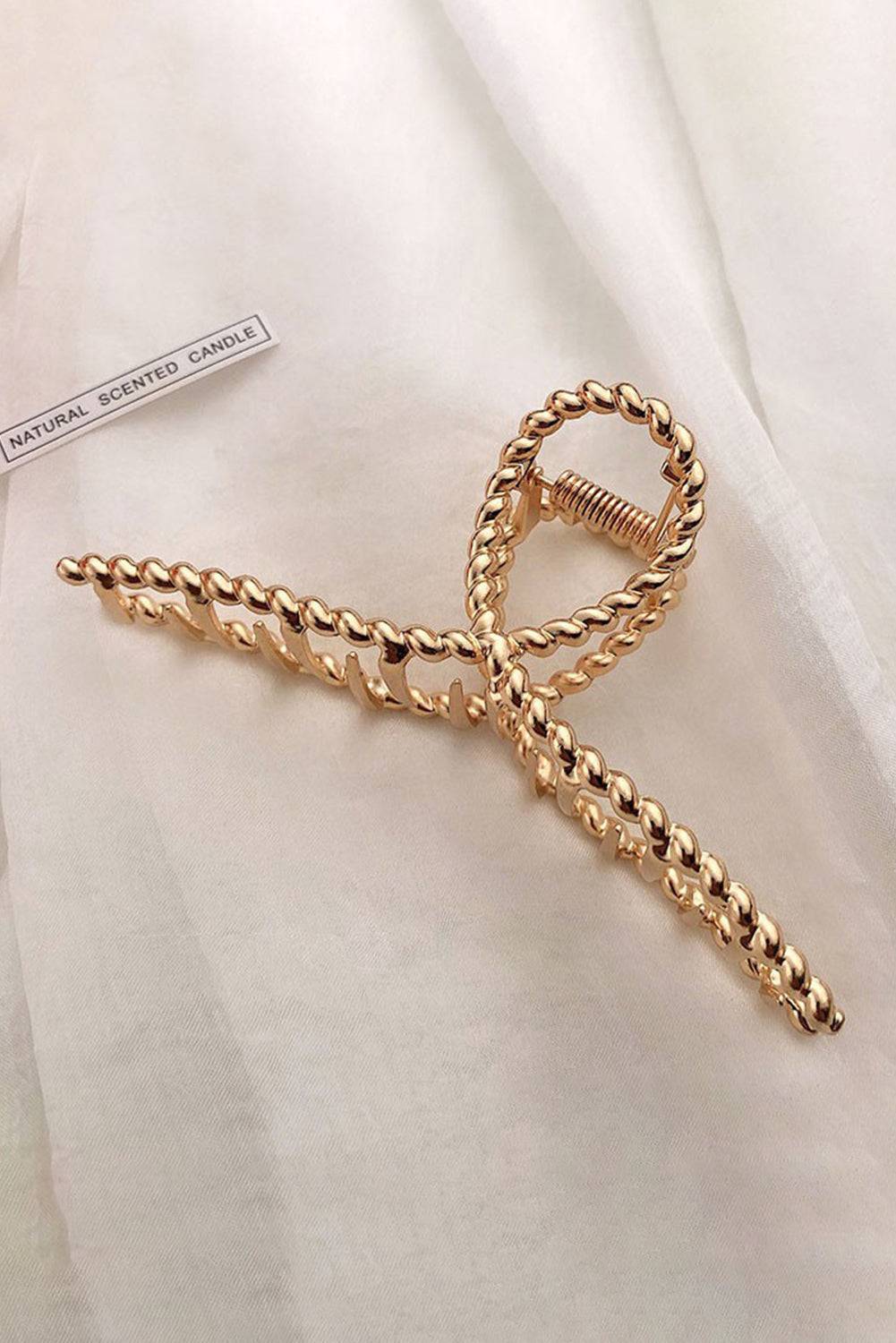 Gold chain tie on a white fabric background
