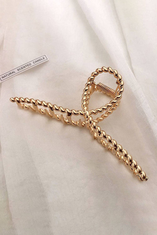 Gold chain tie on a white fabric background