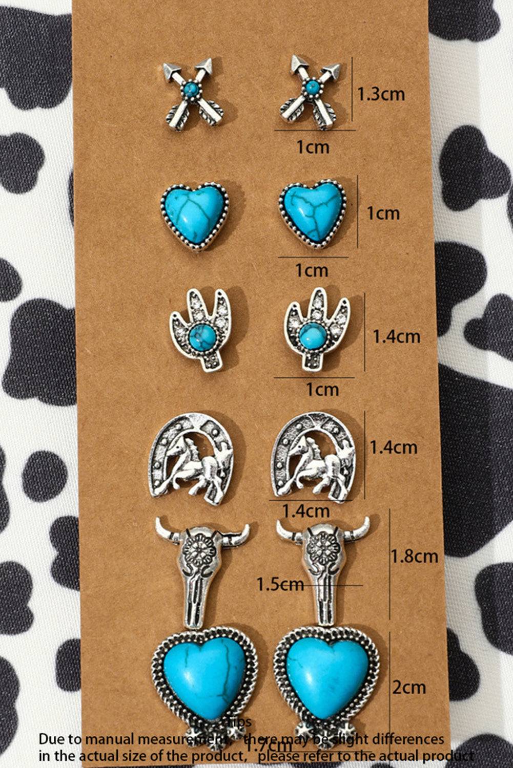Set of earrings with turquoise stones on a brown card with measurements.