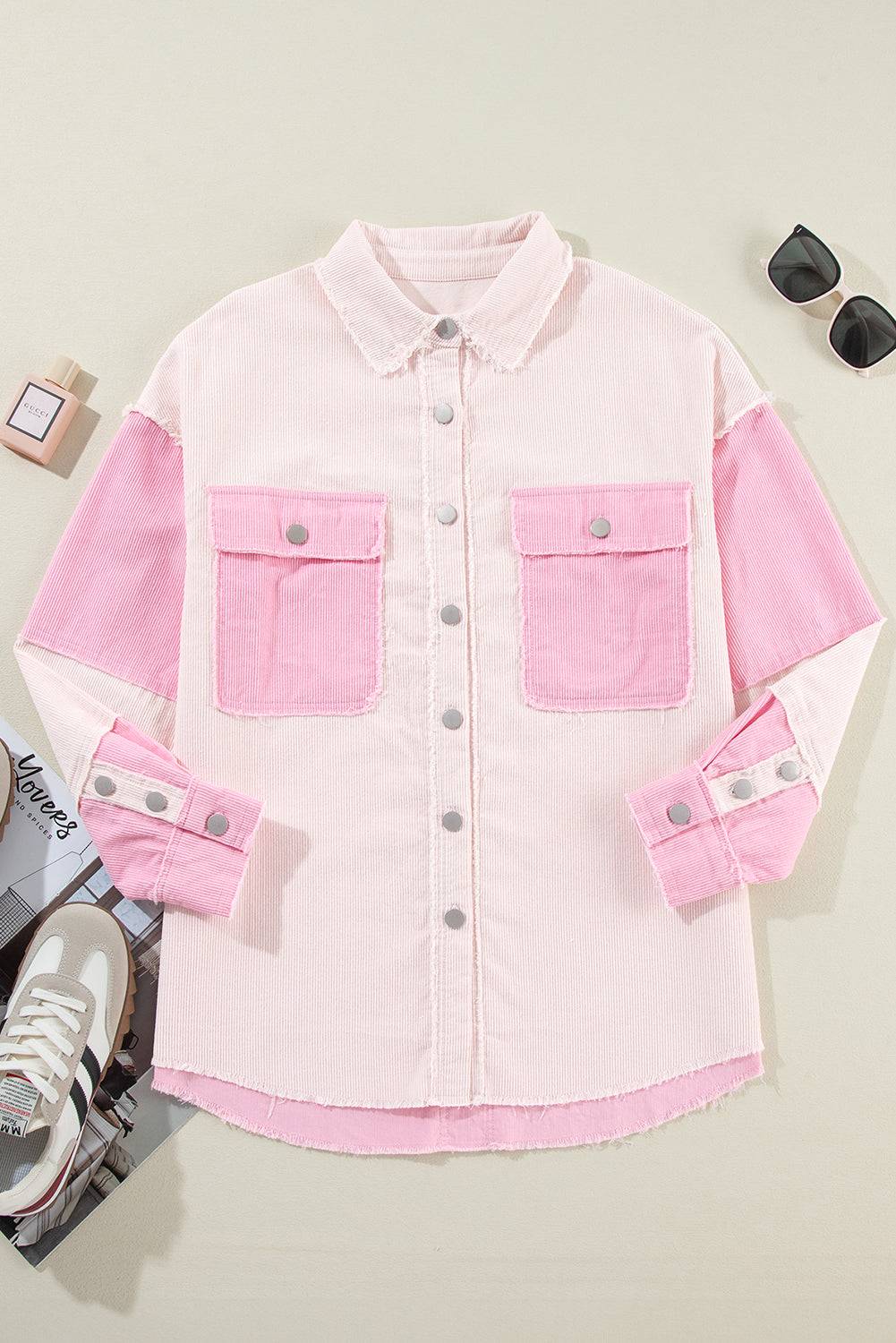 Pink denim jacket with two front pockets on a light gray background