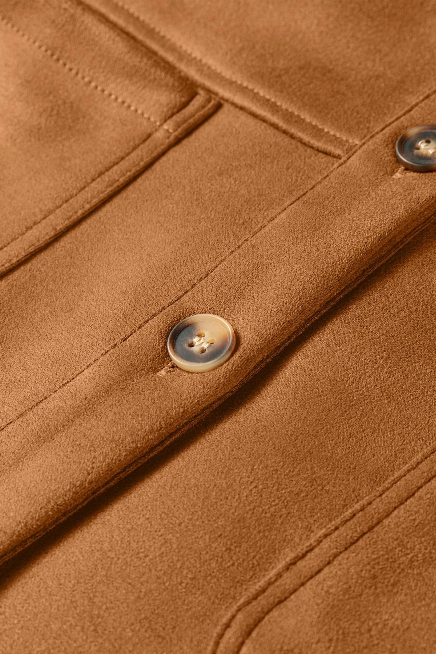 Close-up of a brown leather jacket with buttons