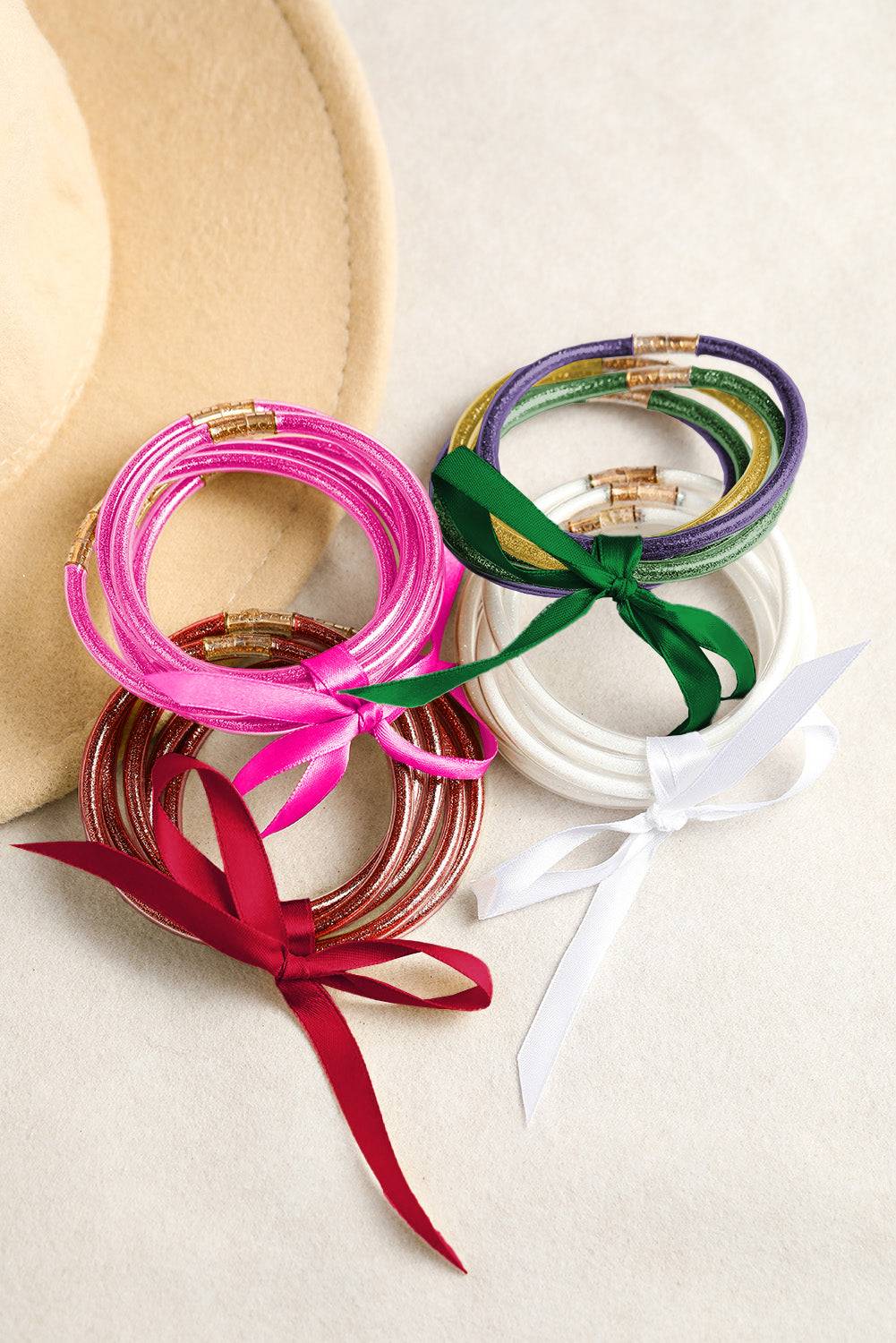 Colorful bangles with ribbons on a white surface
