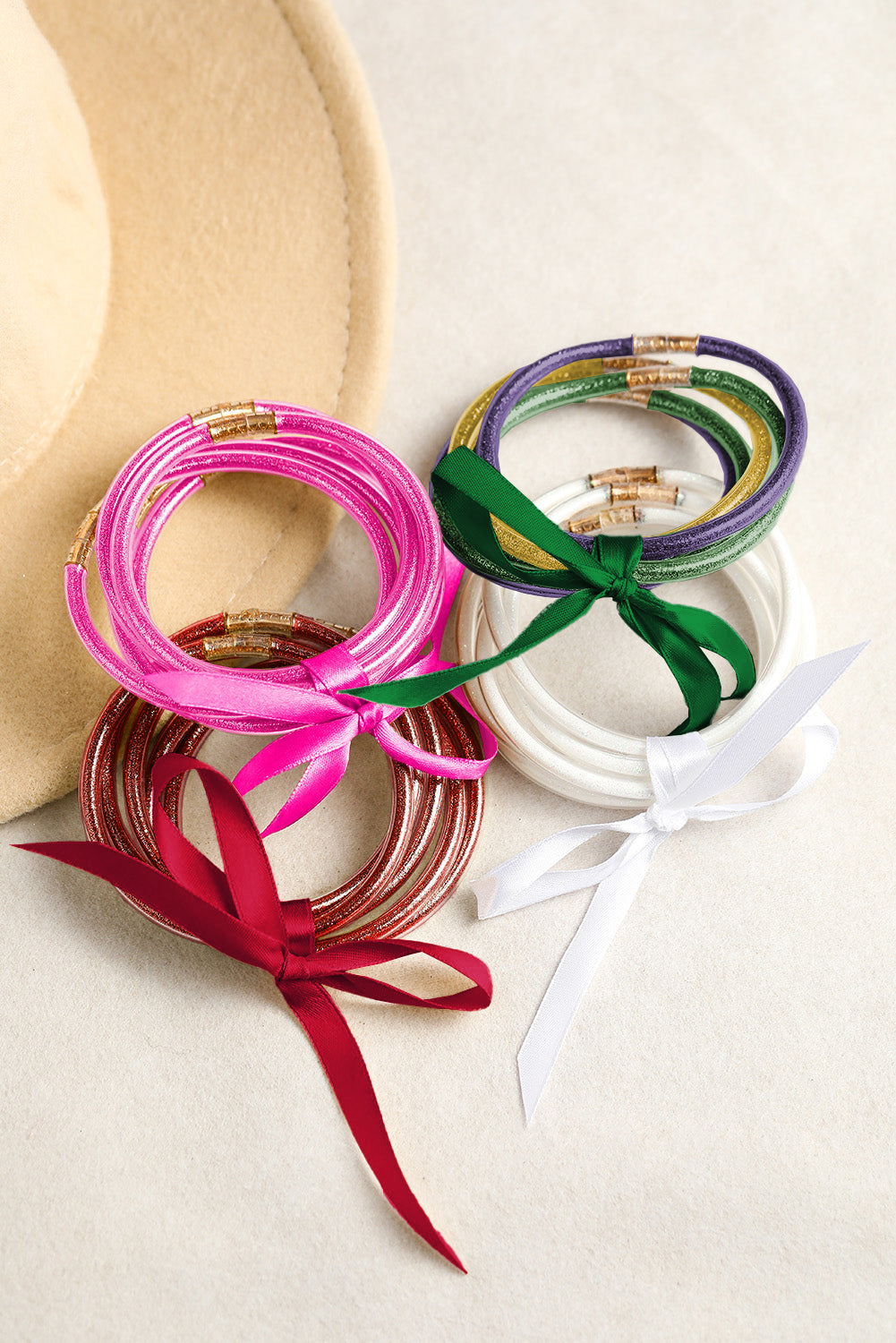Colorful bangles with ribbons on a white surface