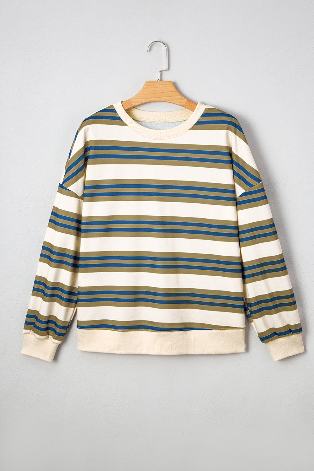 Striped long-sleeve shirt on a hanger against a gray background