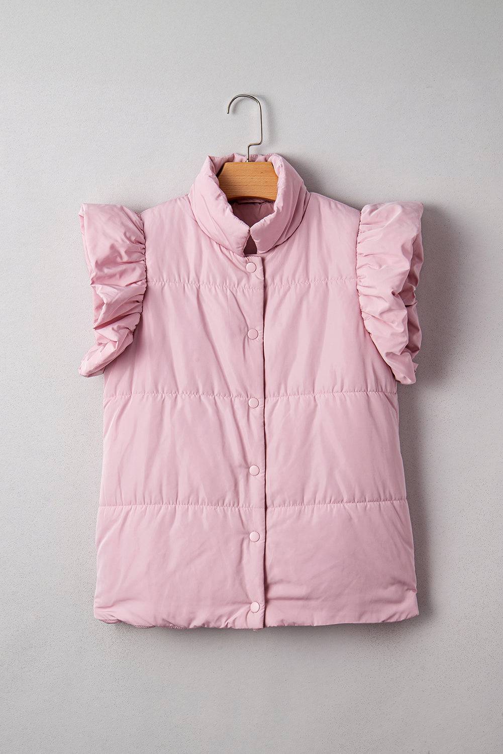 Pink puffer vest with ruffled sleeves on a hanger against a gray background