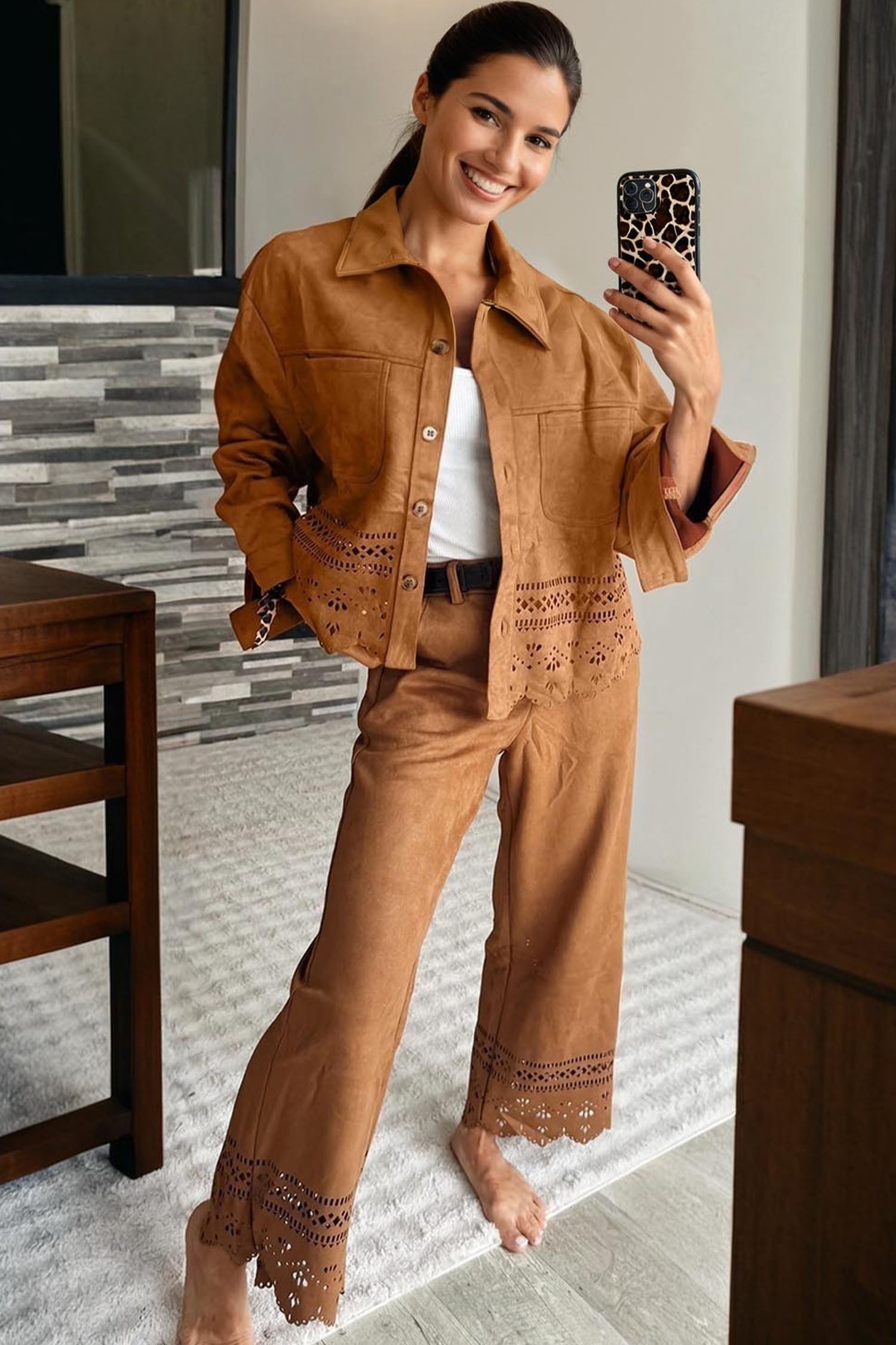 Woman taking a mirror selfie wearing a brown outfit with lace details.