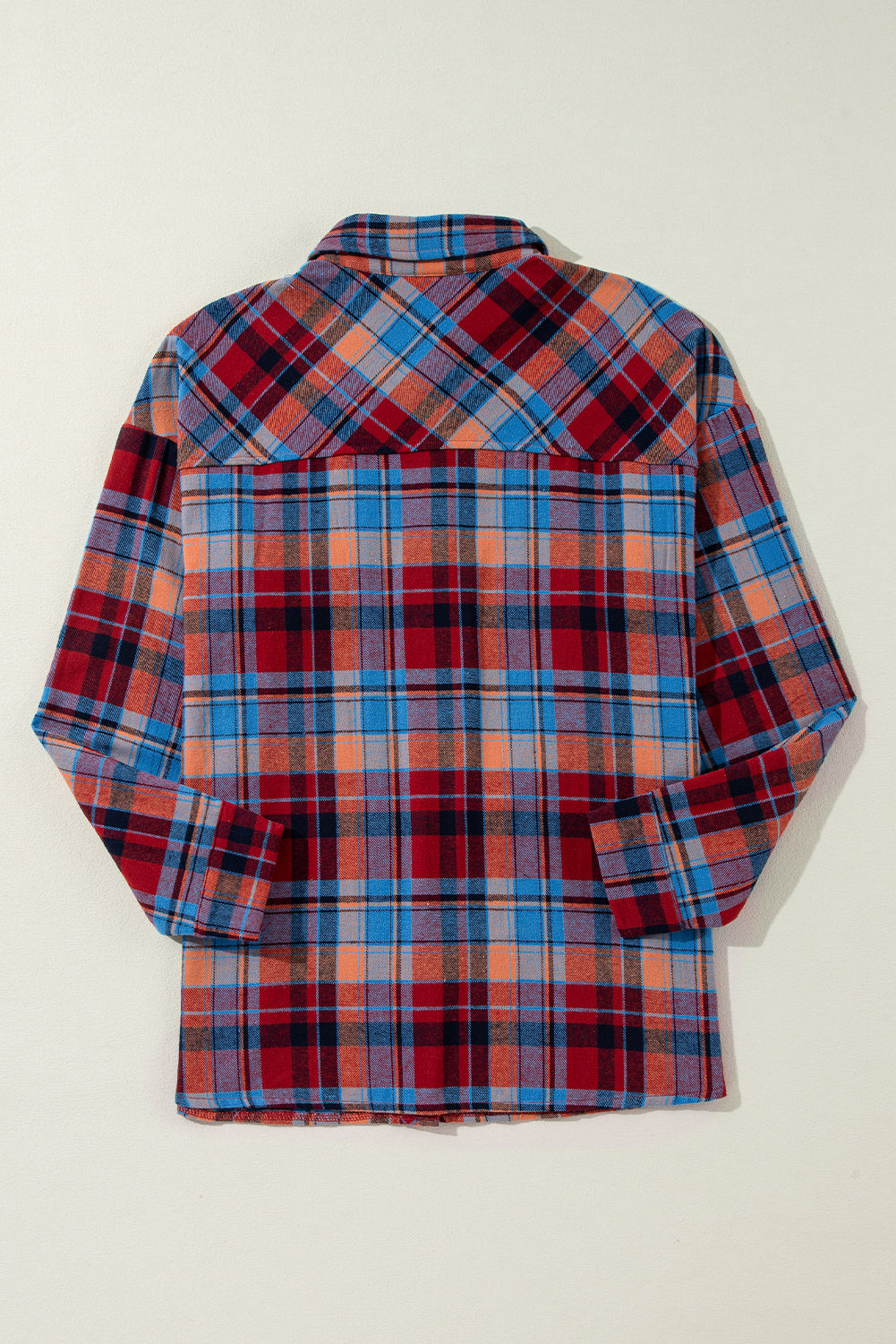 Plaid shirt with red, blue, and orange pattern on a white background