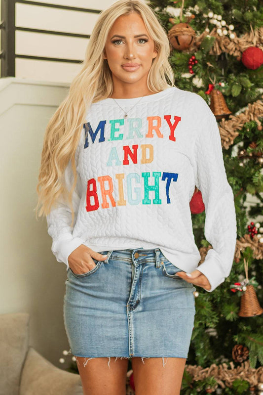 Woman wearing a colorful 'Merry and Bright' sweater 