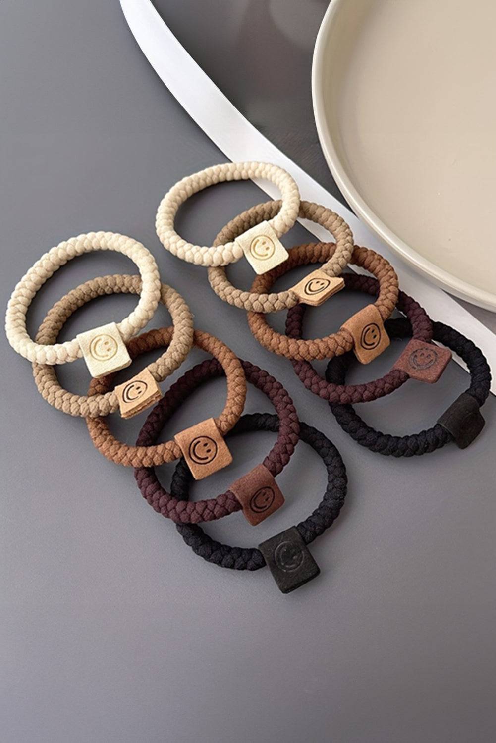 Set of hair ties with decorative clasp on a gray surface
