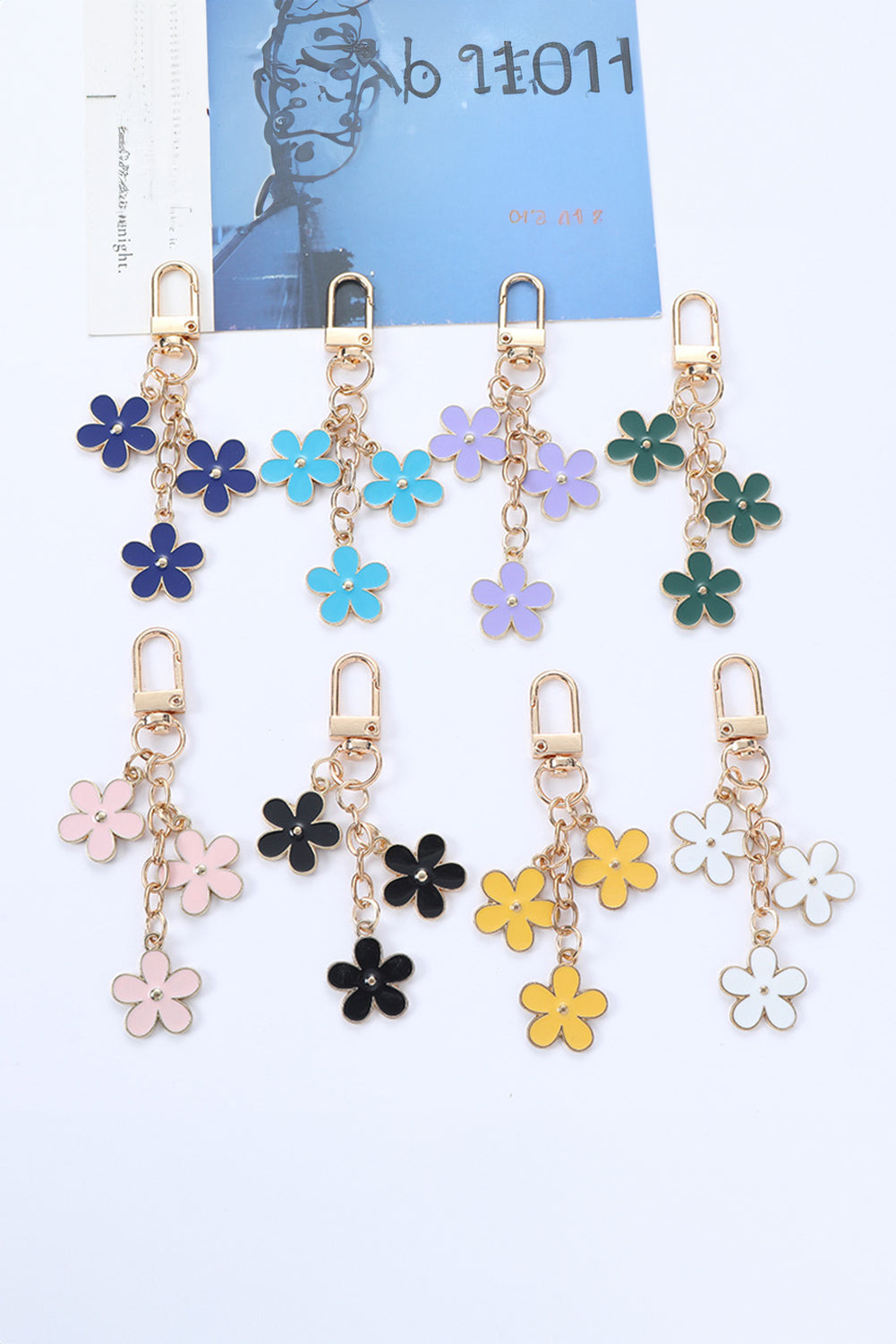 Set of colorful flower-shaped keychains on a white background