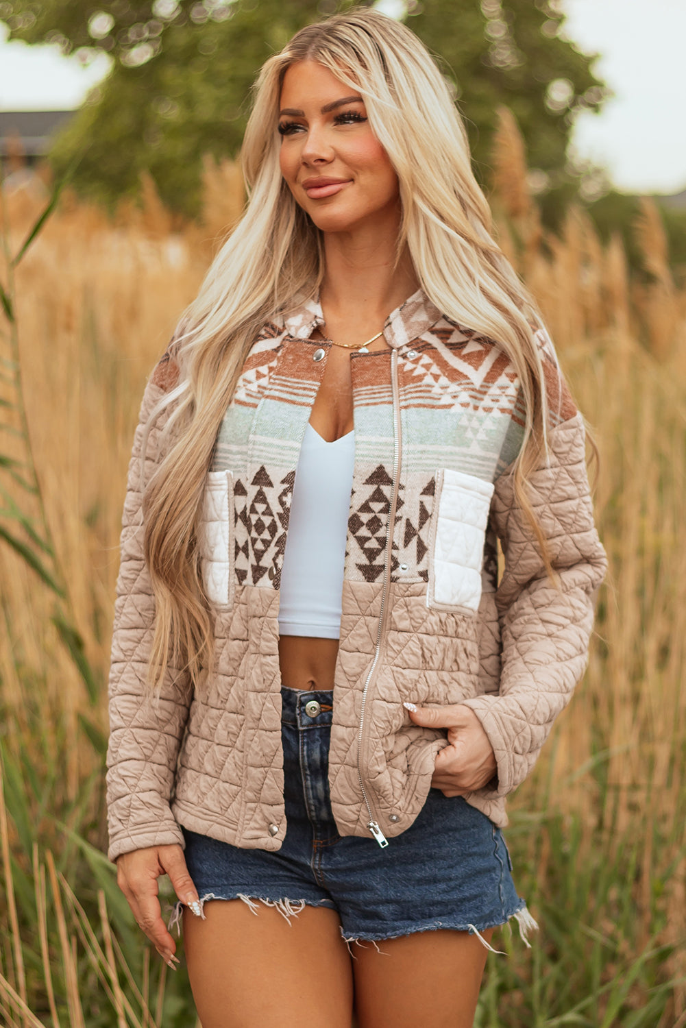 Woman wearing a patterned jacket in a field